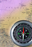The Black compass on old vintage map, macro background