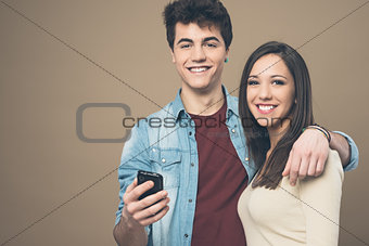 Cheerful young couple with mobile phone