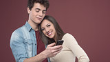 Young teen couple with smartphone