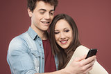 Young teen couple with smartphone