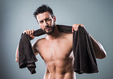 Cool athletic man posing with towel
