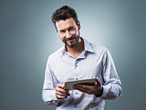 Smiling confident man with tablet