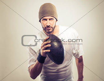 Handsome football player with ball