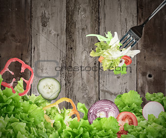 Background of mixed salad on wooden boards