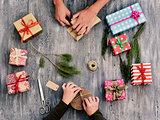 young woman and man wrapping gifts