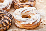 Chocolate and powdered sugar cream puff rings (choux pastry)