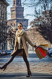 smiling elegant woman in fur coat in Milan, Italy walking