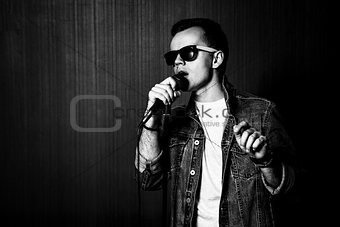 Guy Singing with Microphone. Black and White.