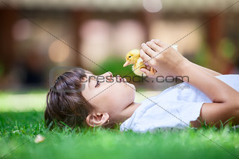 Cute girl with a spring duckling