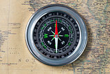 the Black compass on old vintage map, macro background