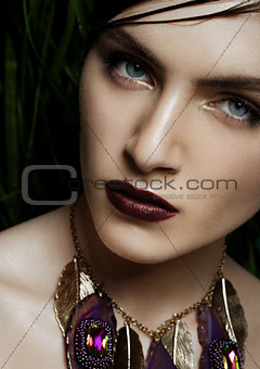 Beautiful woman wearing exotic tropical jewelry