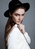 Beautiful fashion model in white with black hat