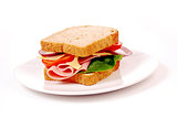 Healthy ham sandwich with cheese, tomatoes on white background