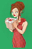 Beautiful young woman holding gift box on Valentines Day