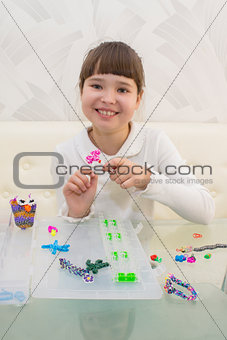 A smiling girl with a fashionable hairstyle with trendy handmade weaving bracelets on a white background