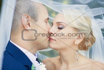 The bride kisses the groom gently