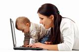 mother and baby girl having fun with laptop