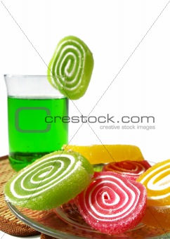 Multi-coloured  fruit candy and cold green drink