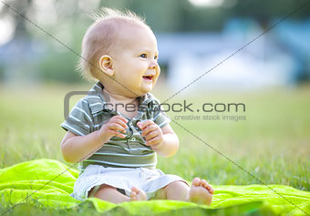 Happy small boy outdoors in a park