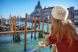 Venetian mask in hand of woman in Venice, Italy