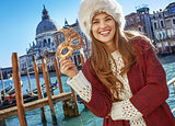 happy modern woman in Venice, Italy with Venetian mask
