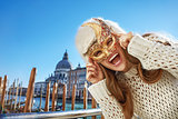 Portrait of happy woman in Venice, Italy wearing Venetian mask