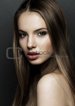 Beautiful woman model portrait with long hair on black