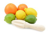 Six citrus fruits with a wooden reamer