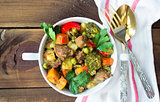 served beef meat stewed with vegetables in ceramic pot on wooden background