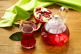 Fruit pomegranate tea in a teapot and cup