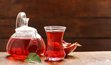 Fruit pomegranate tea in a teapot and cup