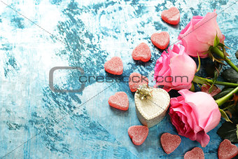 Pink flowers of roses and candy hearts for Valentines holiday
