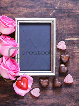 Pink rose flowers, frame for text and hearts for Valentines holiday