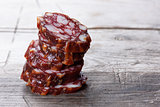 slices of Salami on wooden background