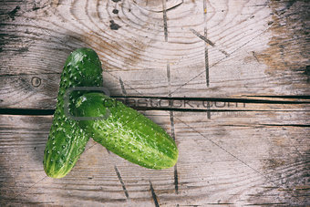 two fresh cucumbers on wooden table