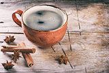 Coffee cup cinnamon sticks on a wooden table. 