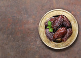 Sweet dried figs dates in a plate on the table