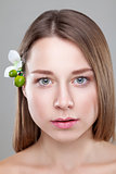 Beautiful brunette woman with a flower in hair