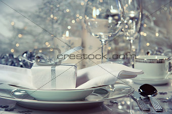 Closeup of dinner setting with gift for the holidays