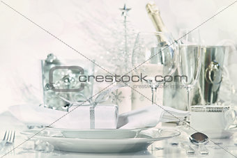 Holiday place setting with glasses and champagne
