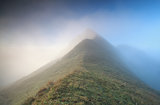 mountain peak in dense fog