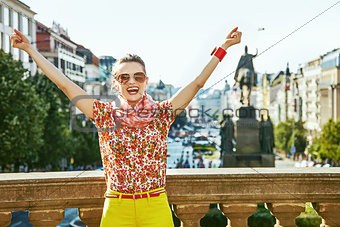 tourist woman on Wenceslas Square in Prague rejoicing