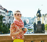 woman on Vaclavske namesti in Prague with digital camera