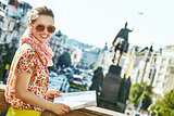 smiling young tourist woman in Prague Czech Republic with map