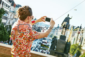 woman in Prague Czech Republic taking photo with mobile phone