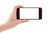 Hand holding black smart phone isolated on white