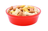 Dry bone-shaped dog biscuits in a red pet food bowl