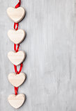 Love concept. Hearts hanging on grey background