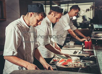 Busy chefs at work in the restaurant kitchen