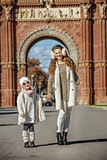 mother and child standing near Arc de Triomf in Barcelona